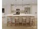 Modern kitchen featuring a spacious island with seating, stainless steel appliances, and stylish pendant lighting at 4969 Fitzgerald Ave, Charlotte, NC 28213