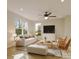Inviting living room with a comfortable sofa, stylish armchairs, large windows, and a ceiling fan at 4969 Fitzgerald Ave, Charlotte, NC 28213