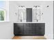 Bathroom featuring black cabinets, dual sinks, and modern lighting at 506 Legrand St, Shelby, NC 28150