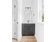 Modern powder room featuring a dark vanity with a white countertop and stylish mirror at 506 Legrand St, Shelby, NC 28150