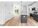 Open kitchen design with stainless steel appliances, island, modern light fixture, and access to backyard at 506 Legrand St, Shelby, NC 28150
