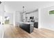Modern kitchen boasts stainless steel appliances, island with seating, and stylish white and black cabinetry at 506 Legrand St, Shelby, NC 28150