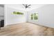 Bright living space with windows, ceiling fan, and wood flooring at 506 Legrand St, Shelby, NC 28150
