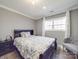 Neutral bedroom with a gray accent wall, queen bed, armchair and large window at 605 Allen Way, Indian Trail, NC 28079