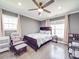 Serene bedroom featuring a queen bed, a rocking chair, and sun-filled windows perfect for a Bedroom at 605 Allen Way, Indian Trail, NC 28079