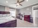 Bright bedroom with a crib, queen bed, ceiling fan, and changing table at 605 Allen Way, Indian Trail, NC 28079
