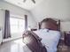 Bright bedroom featuring large windows, decorative headboard, and wood floors, creating a tranquil space at 605 Allen Way, Indian Trail, NC 28079