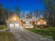 Charming home featuring a stone facade, attached garage, and well-manicured front yard at 605 Allen Way, Indian Trail, NC 28079