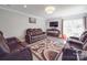 Relaxing living room featuring comfortable recliners, a modern TV, and a cozy atmosphere for Gathering time at 605 Allen Way, Indian Trail, NC 28079