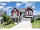 Charming two-story home with a well-maintained lawn and a welcoming two-car garage at 16718 Keene Ct, Charlotte, NC 28278