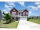 Charming two-story home with a well-maintained lawn and a welcoming two-car garage at 16718 Keene Ct, Charlotte, NC 28278