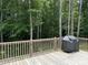 A view from the back deck, featuring a grill, wooden deck, wooden railing and views of lush trees at 185 Crystal Bay Dr, Mooresville, NC 28115