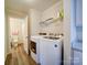 Functional laundry room with washer, dryer, utility sink and adjacent half bathroom at 185 Crystal Bay Dr, Mooresville, NC 28115