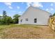 Spacious backyard featuring a concrete patio, privacy fence, and lush green lawn at 2363 Reepsville Rd, Lincolnton, NC 28092