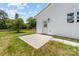 Cozy backyard featuring a concrete patio, lush green lawn, a private fence, and a bright back door at 2363 Reepsville Rd, Lincolnton, NC 28092
