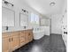 A bright bathroom offers double sinks, sleek black hardware, and a modern tub and glass shower at 2363 Reepsville Rd, Lincolnton, NC 28092