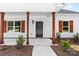 Inviting front entrance featuring wood columns, black front door, and meticulously manicured landscaping at 2363 Reepsville Rd, Lincolnton, NC 28092