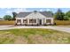 Charming home featuring wood accents, a dark roof, complemented by professionally landscaped front yard at 2363 Reepsville Rd, Lincolnton, NC 28092