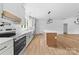 Bright, modern kitchen with stainless steel appliances, white cabinets, and a spacious center island at 2363 Reepsville Rd, Lincolnton, NC 28092