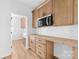 Kitchenette featuring custom cabinets, white backsplash, wood countertop and stainless microwave at 2363 Reepsville Rd, Lincolnton, NC 28092