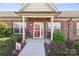 Inviting front entrance with covered porch, seating, and manicured bushes, showcasing a cozy welcome at 2783 Clover Nw Rd, Concord, NC 28027