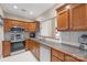 Traditional kitchen with stainless steel appliances and wood cabinetry, offering ample counter space at 2783 Clover Nw Rd, Concord, NC 28027
