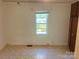 This bedroom features neutral paint, window with blinds, and a built in closet at 301 Louise St, Lancaster, SC 29720