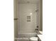 An updated bathroom features a tiled bath/shower combination with built-in shelving for toiletries at 318 Stanback St, Mount Gilead, NC 27306