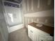 Unfinished bathroom featuring a tub with tile surround and a vanity with a countertop at 318 Stanback St, Mount Gilead, NC 27306