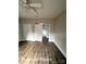 Bedroom with wood floors, closet, and a sliding barn door leading to the bathroom at 318 Stanback St, Mount Gilead, NC 27306