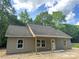 Well-lit single-story home showing vinyl siding and covered porch at 318 Stanback St, Mount Gilead, NC 27306