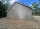 Side view showing vinyl siding and a minimalist architectural style at 318 Stanback St, Mount Gilead, NC 27306