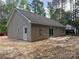 Rear view showing vinyl siding, a patio, and an exterior door at 318 Stanback St, Mount Gilead, NC 27306