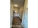 Hallway leading to the kitchen featuring wood-look flooring, neutral walls, and a utility sink at 318 Stanback St, Mount Gilead, NC 27306