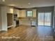 Bright kitchen featuring white cabinets, modern appliances, and sliding doors to the outdoors at 318 Stanback St, Mount Gilead, NC 27306