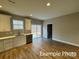 Well-lit kitchen featuring white cabinets, stainless appliances, and a sliding door to the outside at 318 Stanback St, Mount Gilead, NC 27306