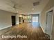 Spacious living room featuring wood floors, a ceiling fan, and a view of the kitchen at 318 Stanback St, Mount Gilead, NC 27306