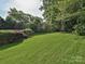 A luscious green backyard with manicured lawn and landscaping at 557 S Portman Ln, Fort Mill, SC 29708