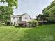 Backyard with a lush lawn, mature landscaping, and rear exterior at 557 S Portman Ln, Fort Mill, SC 29708