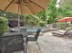 Backyard patio with an outdoor dining set, lounge chairs, and a beautiful pool at 557 S Portman Ln, Fort Mill, SC 29708