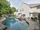 Backyard view of a charming pool and the rear of the home at 557 S Portman Ln, Fort Mill, SC 29708
