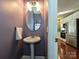 Powder room featuring pedestal sink and mirror, with a glimpse of the updated kitchen at 557 S Portman Ln, Fort Mill, SC 29708
