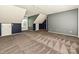 Large bedroom with blue and white walls, tan carpet, and an interesting ceiling line at 557 S Portman Ln, Fort Mill, SC 29708