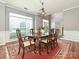 Formal dining room with a large window, chandelier, and hardwood floors at 557 S Portman Ln, Fort Mill, SC 29708