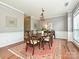 Formal dining room with a large window, chandelier, and hardwood floors at 557 S Portman Ln, Fort Mill, SC 29708