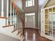Bright foyer featuring hardwood floors, a staircase, and a view of the front entrance at 557 S Portman Ln, Fort Mill, SC 29708