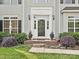 Elegant front entry with a white door, sidelights, and decorative landscaping at 557 S Portman Ln, Fort Mill, SC 29708