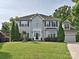 Traditional two-story home with a well-manicured lawn and mature landscaping at 557 S Portman Ln, Fort Mill, SC 29708