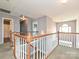 Upstairs hallway view featuring wood and white railing and light-filled landing at 557 S Portman Ln, Fort Mill, SC 29708