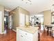Open kitchen view showing an island with seating, open floorplan, and views to the living room at 557 S Portman Ln, Fort Mill, SC 29708
